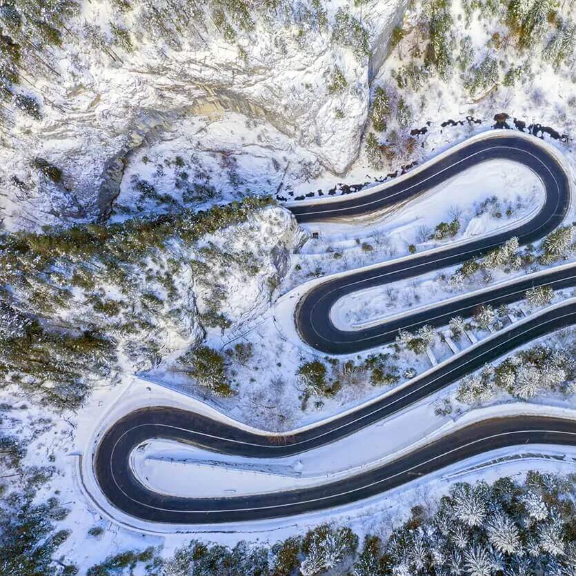 aerial view of road zig-zag during winter season